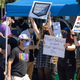 Activision Blizzard employees protest outside the Blizzard offices, holding signs like "Women's Voices Matter!" and "Nerf Male Privilege".